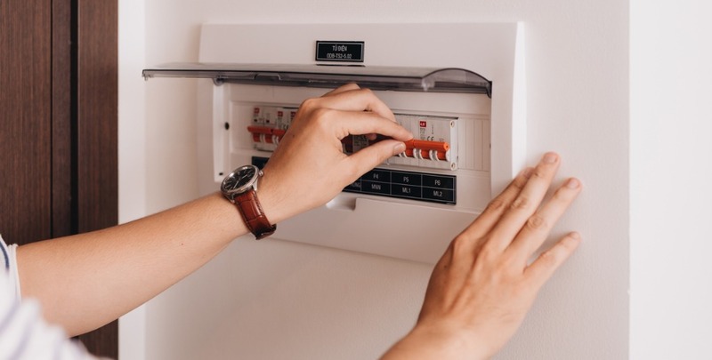 circuit breaker board displays many switches a finger is about to it picture