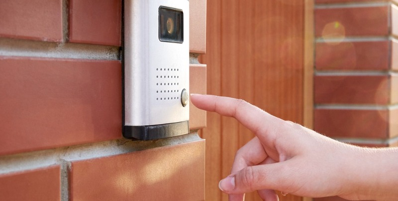 the female hand presses a button doorbell with camera and intercom picture