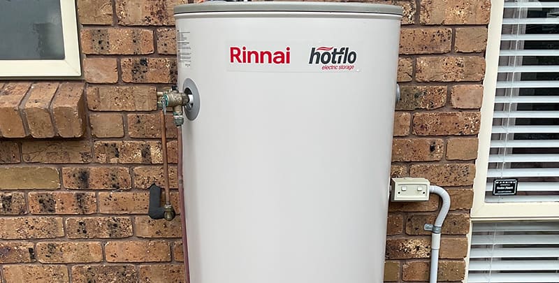 Rinnai Hotflo electric hot water system installed on the wall of a house.