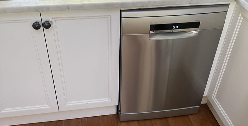 Finished result of a dishwasher installation in a home kitchen.